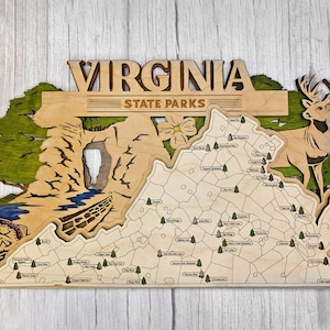 May include: Wooden Virginia State Parks map with laser-cut details. Features a map of Virginia with state park locations, a deer, and scenic elements. The word "VIRGINIA" is at the top.