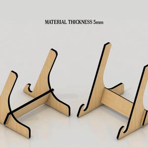 May include: Two wooden phone stands, each with a simple design and black trim. The stands are made of 5mm thick material. MATERIAL THICKNESS 5mm