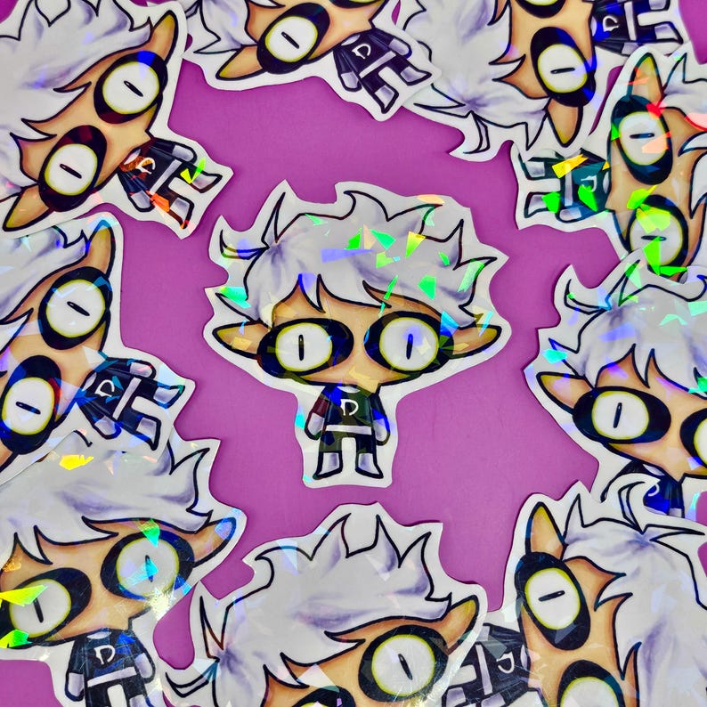 May include: A collection of stickers featuring a cartoon character with white hair, large oval eyes, and a small black and green outfit. The stickers have a holographic, iridescent finish, and are arranged on a purple background.