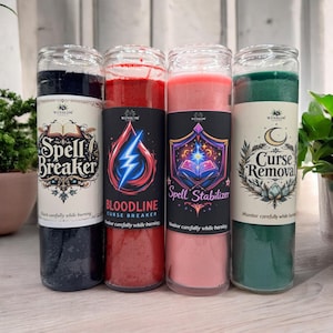 May include: Four glass jar candles with labels reading "Spell Breaker," "Bloodline Curse Breaker," "Spell Stabilizer," and "Curse Removal." The candles are black, red, pink, and green. Each label has a unique design and the brand name "Winslow."