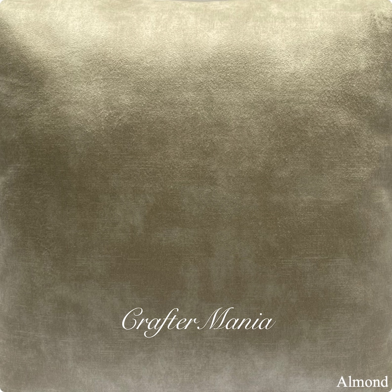 May include: A close-up of a soft, textured, beige fabric with a subtle sheen. The fabric has a slightly wrinkled appearance and the text "Crafter Mania" is printed in white in the lower center of the image. The word "Almond" is printed in white in the lower right corner of the image.
