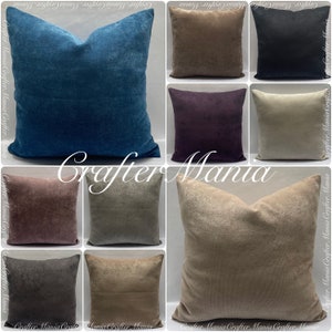 May include: Collection of square throw pillows in various colors, including teal, brown, black, purple, beige, and gray. The pillows have a soft, textured appearance. The text "Crafter Mania" is visible across the image.