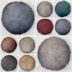 May include: A collection of round decorative pillows in various colors, including shades of blue, gray, red, and brown. The pillows have a textured appearance and are arranged in a grid pattern. The image includes the text "Crafter Mania".