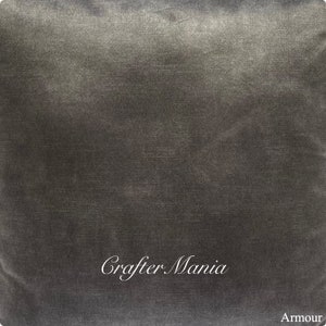 May include: A dark gray, textured fabric with the words "Crafter Mania" and "Armour" printed in white.