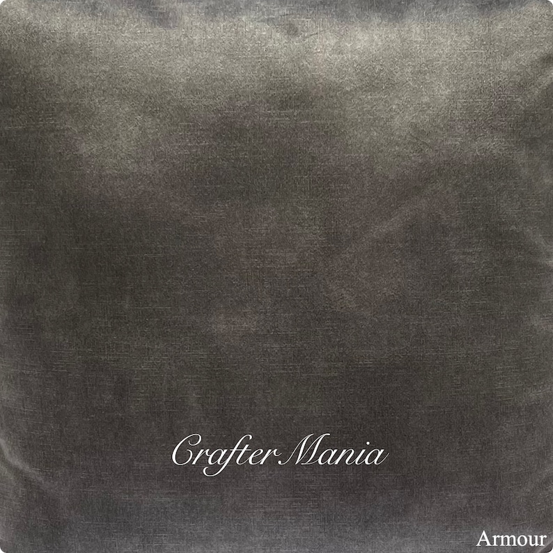 May include: A dark gray, textured fabric with the words "Crafter Mania" and "Armour" printed in white.