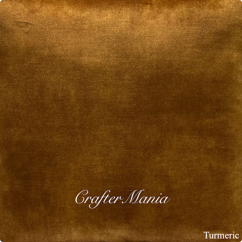 May include: A close-up of a rich, golden brown paint sample with a subtle sheen. The sample is labeled "Turmeric" and the text "Crafter Mania" is written in a decorative script.