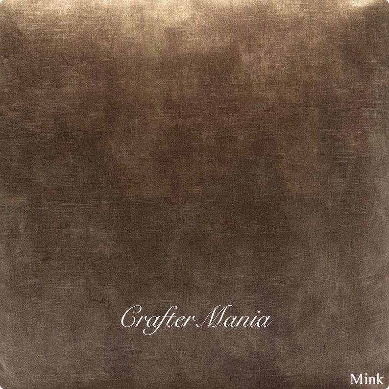 May include: A close-up of a brown fabric with a subtle textured pattern. The fabric has a slightly metallic sheen and is labeled "Crafter Mania" and "Mink".