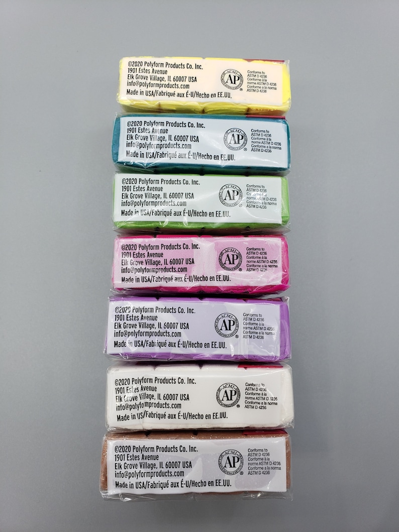 May include: A vertical arrangement of wrapped polymer clay bars in various colours: yellow, teal, green, pink, purple, white, and brown. Each bar has printed labels with manufacturer details and safety information.