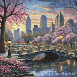 May include: A painting depicting a bridge spanning a river in a city park. The bridge is constructed from stone and features a wrought iron railing. Trees with pink blossoms line either side of the bridge. The city skyline is visible in the background. The sky is a soft blue with pink and orange clouds.