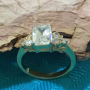 Vintage Emerald Cut CZ Ring, with round CZ on sides, set into Gold Tone Band, Size 6.5
