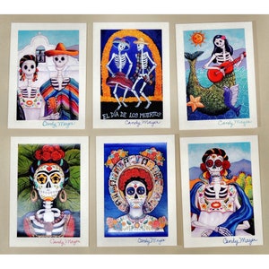 May include: A set of six rectangular art prints by Candy Mayer featuring colorful illustrations of skeletons in various settings, including a couple in front of a church, dancing figures, a mermaid, and portraits adorned with flowers and traditional patterns.