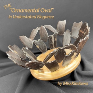 May include: A brown wooden bowl with a unique oval shape, made from many small pieces of wood. The bowl is on a black surface and has the text "THE "Ornamental Oval" in Understated Elegance" above it and "by MissKimSews" below it.