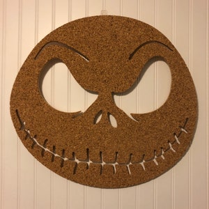May include: A corkboard shaped like Jack Skellington's face from the movie "The Nightmare Before Christmas".