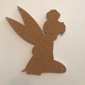 May include: A brown corkboard cutout of a fairy with wings and a flower in her hair.
