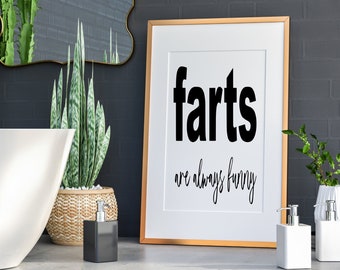 May include: A gold framed print with the text "farts are always funny" in black lettering on a white background.