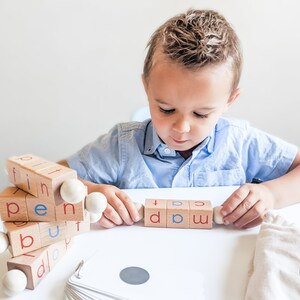 Boy learning reading using Little Bud Kids Spin-and-Read Blocks