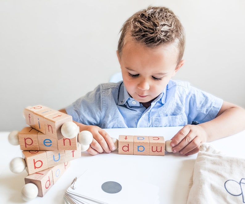 Boy learning reading using Little Bud Kids Spin-and-Read Blocks
