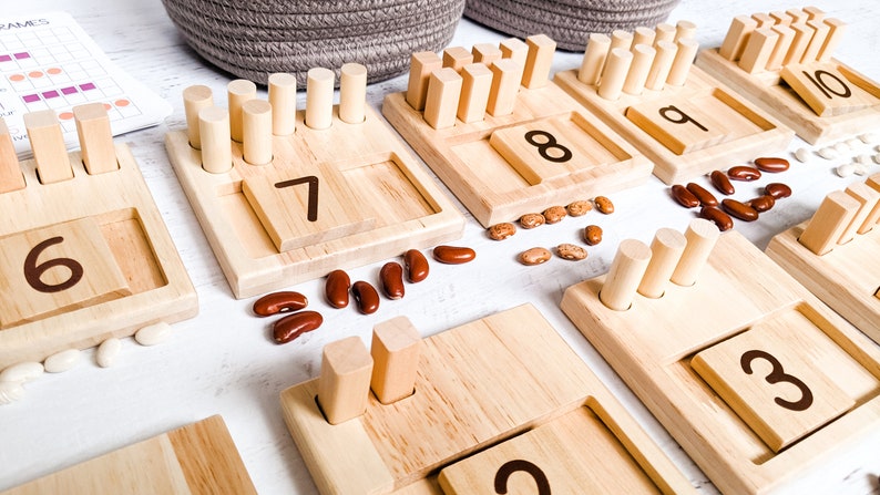 You can use a variety of math counters and math manipulatives with our Little Bud Kids Counting Pegs Math Material. Here, the rectangular cut-out of our number panels allows you to use pebbles, beans, rice, & sand for more number practice.
