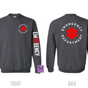 May include: A dark gray sweatshirt with a white and red "Emergency Department" logo on the back and a white "Emergency" word on the left sleeve. The logo features a red star of life.