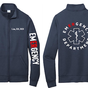 May include: A navy blue zip-up jacket with the words "EMERGENCY" printed in white on the left sleeve and "EMERGENCY DEPARTMENT" with a medical symbol printed in white on the back. The name "Lisa, RN, BSN" is printed on the left chest.