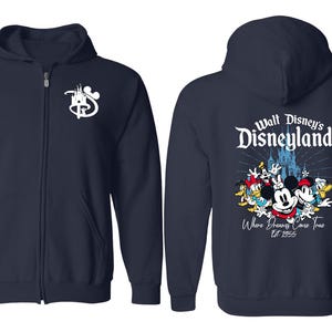 May include: A navy blue zip-up hoodie with a white Disney logo on the left side and a graphic of Mickey Mouse and friends with the text "Walt Disney's Disneyland Where Dreams Come True Est. 1955" on the right side.