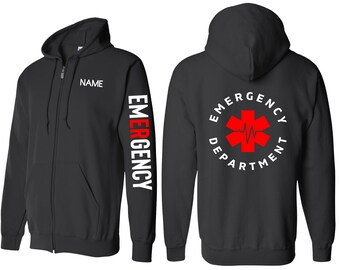 Könnte beinhalten: Schwarzer Kapuzenpullover mit Reißverschluss, auf dem Rücken steht "Emergency Department" und auf dem linken Ärmel "Emergency". Das Design auf der Rückseite zeigt einen roten Stern des Lebens mit einem Herzschlag-Motiv.