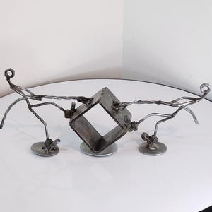 Metal art sculpture of two figures pulling, welded metalwork artistic figurine, scrap metal art