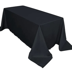 May include: A black rectangular tablecloth with a smooth, wrinkle-free surface. The tablecloth is draped over a table and has a slight overhang on all sides.