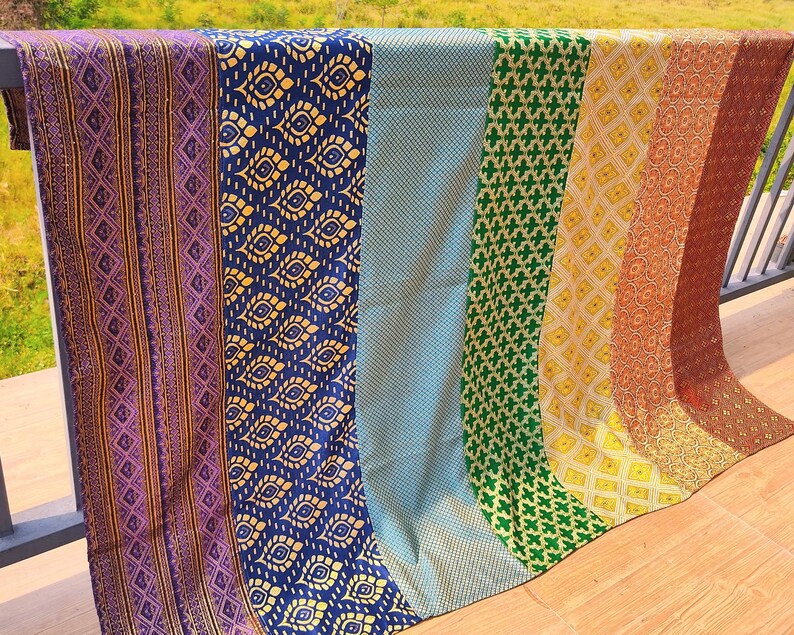 May include: A set of six fabric panels with different patterns. The panels are arranged in a rainbow order, starting with purple and ending with yellow. The panels are made of a soft, silky fabric and have a subtle sheen.