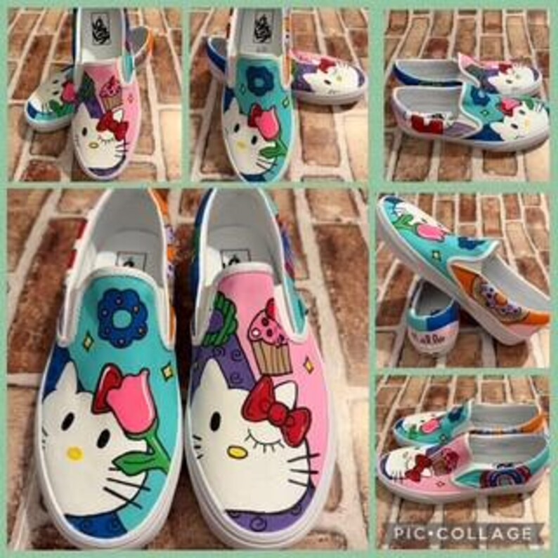 May include: Custom-painted slip-on shoes with a Hello Kitty design. The shoes display white, pink, blue, and red colours, with floral and cupcake accents. The shoes are a size 8.