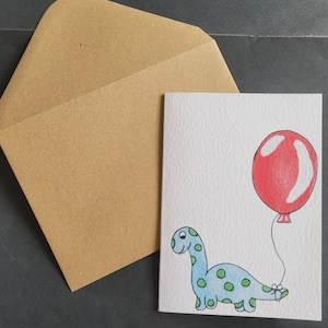 Blauer Dinosaurier mit rotem Ballon A6 Grußkarte (auf strukturierter Karte)