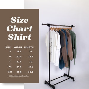 May include: Size chart for shirts with measurements in inches for width and length. The chart shows sizes S, M, L, XL, and 2XL. The measurements are: S - 18.5 inches wide, 27 inches long; M - 20.5 inches wide, 28.5 inches long; L - 22.5 inches wide, 30 inches long; XL - 24.5 inches wide, 31.5 inches long; 2XL - 26.5 inches wide, 32.5 inches long. The chart is on a brown background with the text "Size Chart Shirt" in white.