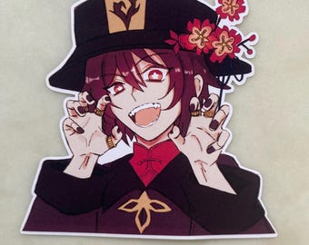 May include: A sticker featuring a cartoon character with red eyes, a wide grin, and a black hat with a gold symbol. The character is wearing a red and black outfit with a gold design. The sticker has a floral design with red flowers.