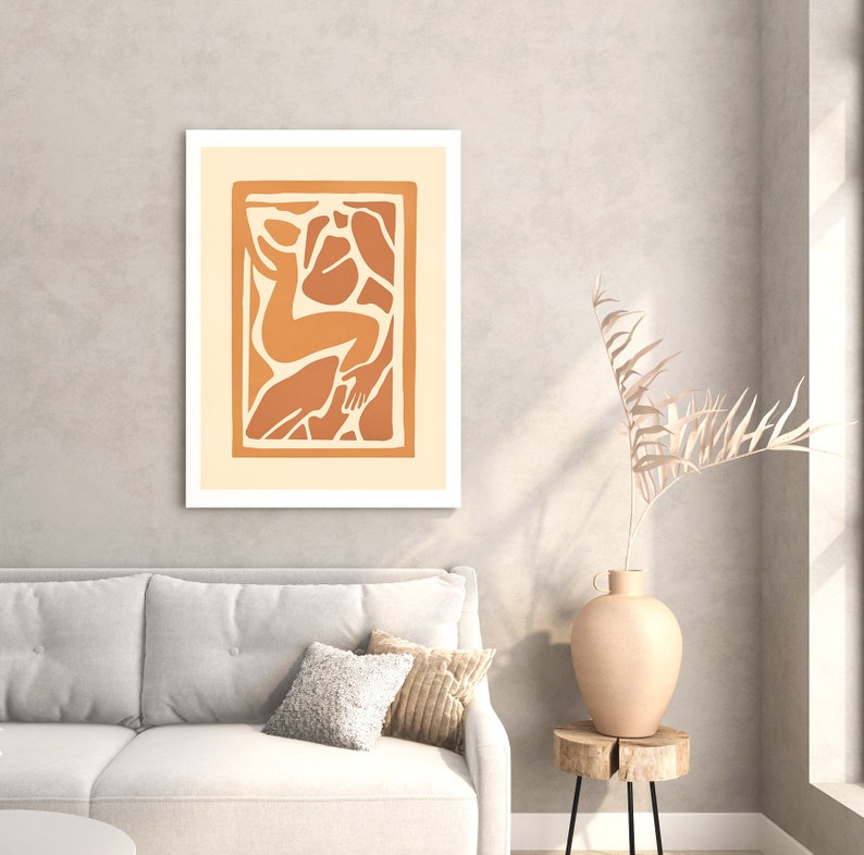 May include: A framed abstract art print with a beige background and a brown silhouette of a person in a stylized pose.