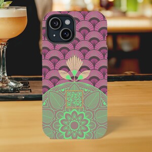 May include: A pink and green phone case with a mandala design and a QR code. The case has a geometric pattern with a flower in the center.