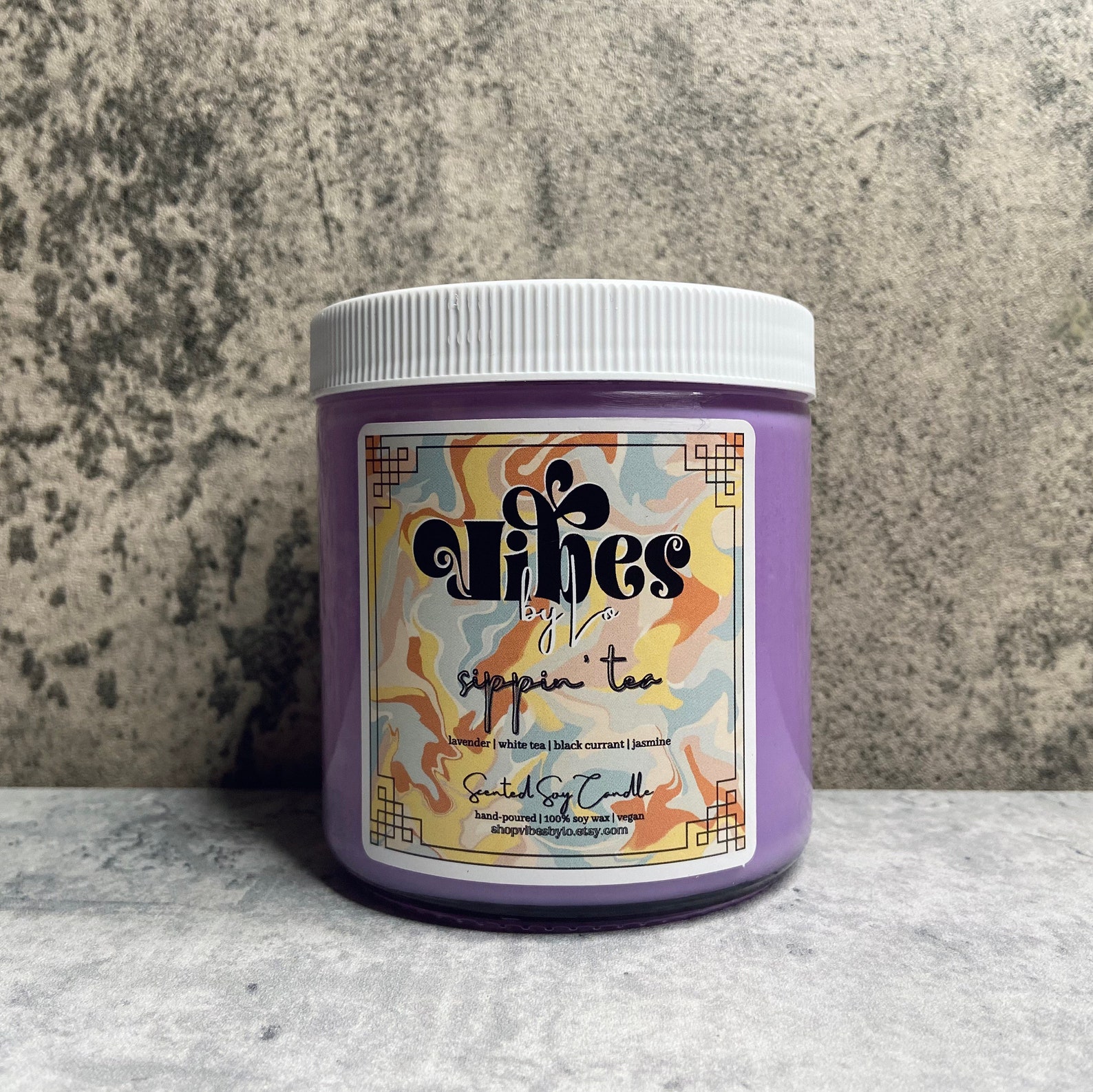 A purple candle with psychedelic artwork.