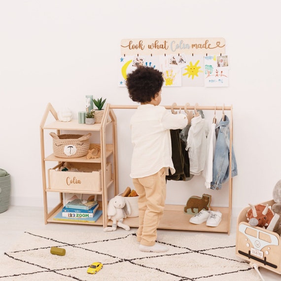 Children clothes on hangers in a room. wardrobe with boy's clothes