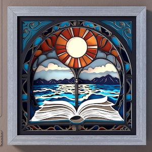 May include: A framed paper art piece with a layered design depicting a book, ocean, and sun. The artwork uses blue, orange, and white hues. The frame is light grey, and the image includes the text "SVG", "DXF", "EPS", "PDF", and "CutCute paper".