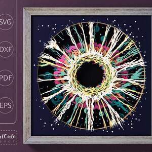 May include: A colorful, abstract design with a black center, resembling a galaxy or a nebula. The design is surrounded by a white background with small white dots.