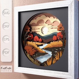 May include: A papercraft design featuring a layered, 3D scene of a river flowing through a forest with a full moon in the sky. The design is framed in a white wood frame and is ready to be cut out and assembled.