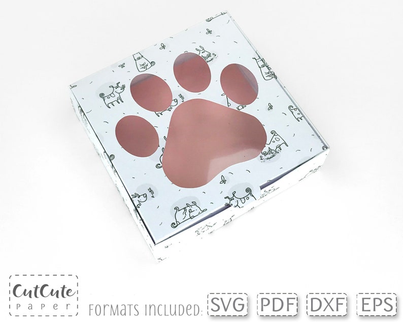 May include: A white box with a paw print design and a cut-out window. The box is decorated with small black and white dog illustrations. The text "CutCute Paper" is visible at the bottom of the image.