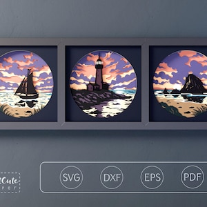 May include: A triptych of framed paper art, each piece illustrating a coastal scene. A sailboat, a lighthouse, and a rock formation are depicted. The circular designs use layered paper cutouts, set against a sunset sky, within a grey frame.