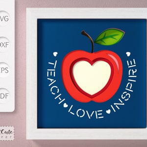 May include: A red apple with a white heart inside, on a blue background. The words "Teach Love Inspire" are written in a circle around the apple.