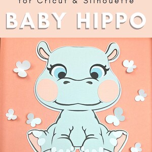 May include: A light pink background with a white banner that says 'Be Gentle' in gold letters. A light blue baby hippo with pink cheeks is sitting on the banner. The hippo has blue eyes and a white outline. There are white butterflies scattered around the hippo.