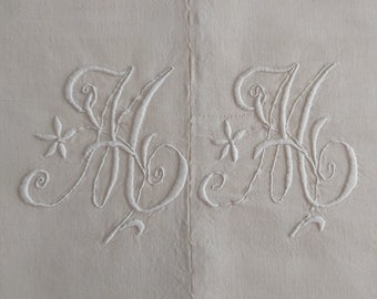 Two available: An antique French narrow-loomed rustic metis sheet with hand embroidered monogram MM in excellent condition.  Early 1900s