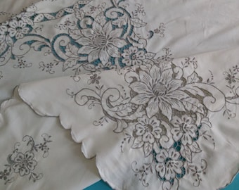 A large hand embroidered vintage French tablecloth, 98 by 63 inches.  Grey on cream.  Superb embroidery, in excellent overall condition