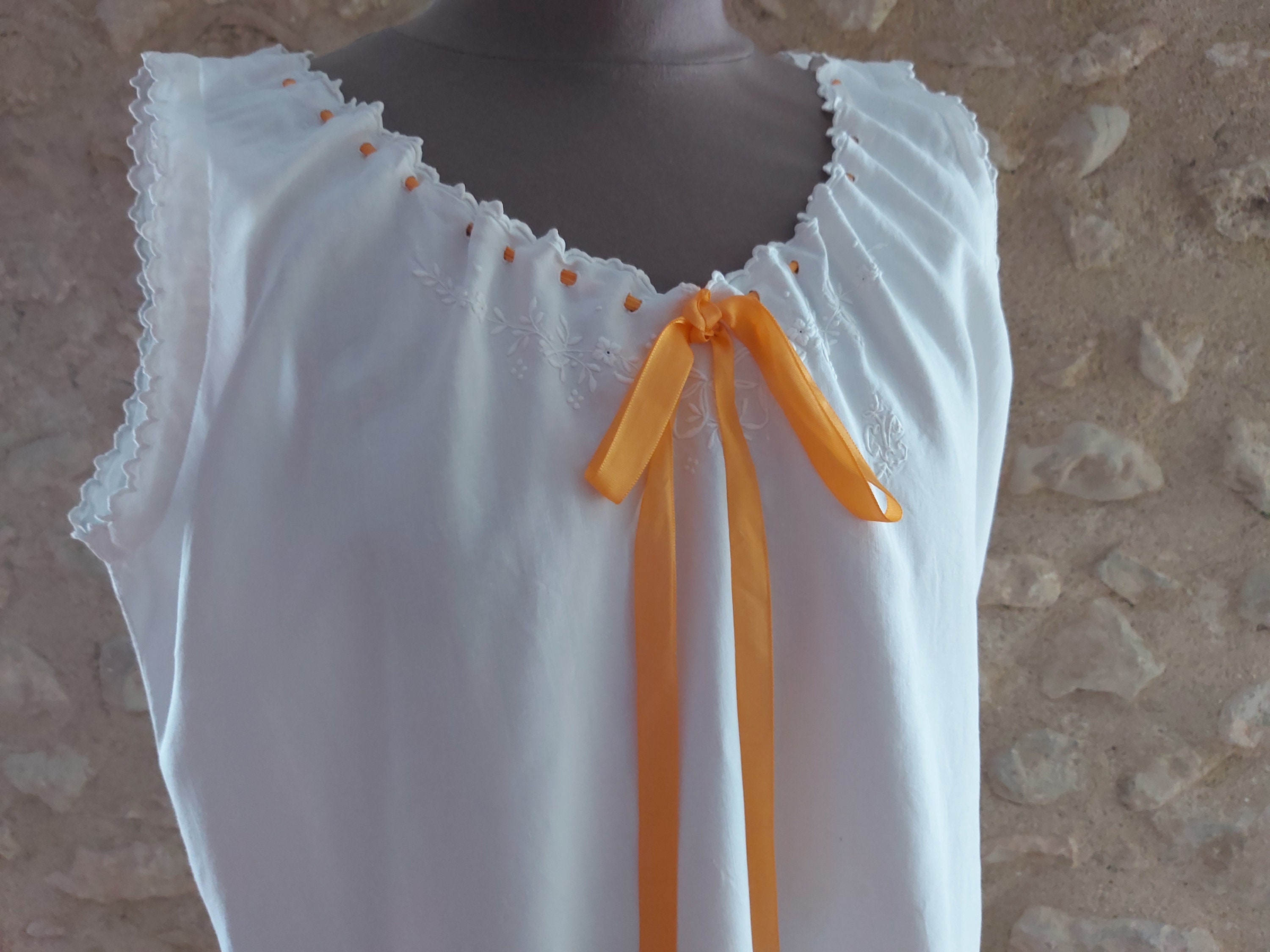 An exquisitely hand embroidered antique French night dress in fine pure linen with flowers and a bow, monogram CV and scalloped edges.  M/L