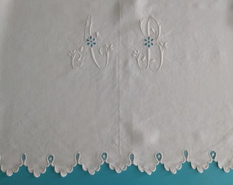 An antique French trousseau sheet in narrow loomed pure linen with hand embroidered monogram AB and rare scalloped and needlelace edge.