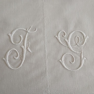Two available: A vintage French heavier weight top sheet with hand embroidered monogram JG.  Narrow loomed, c. 1920s