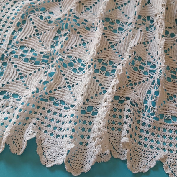 A vintage French bedspread in fine hand crocheted lace with a latticework edge, in cotton thread.  Beautifully textured pattern